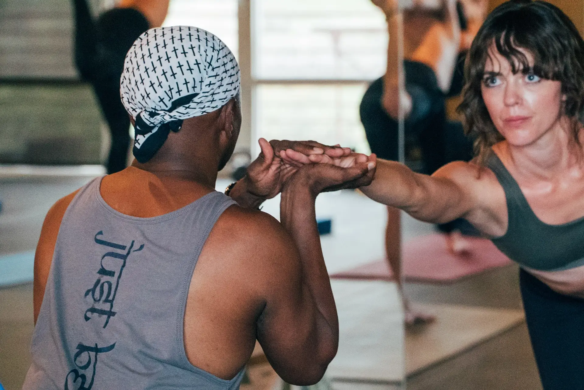 Yoga Instructor Zeek helps guide a student